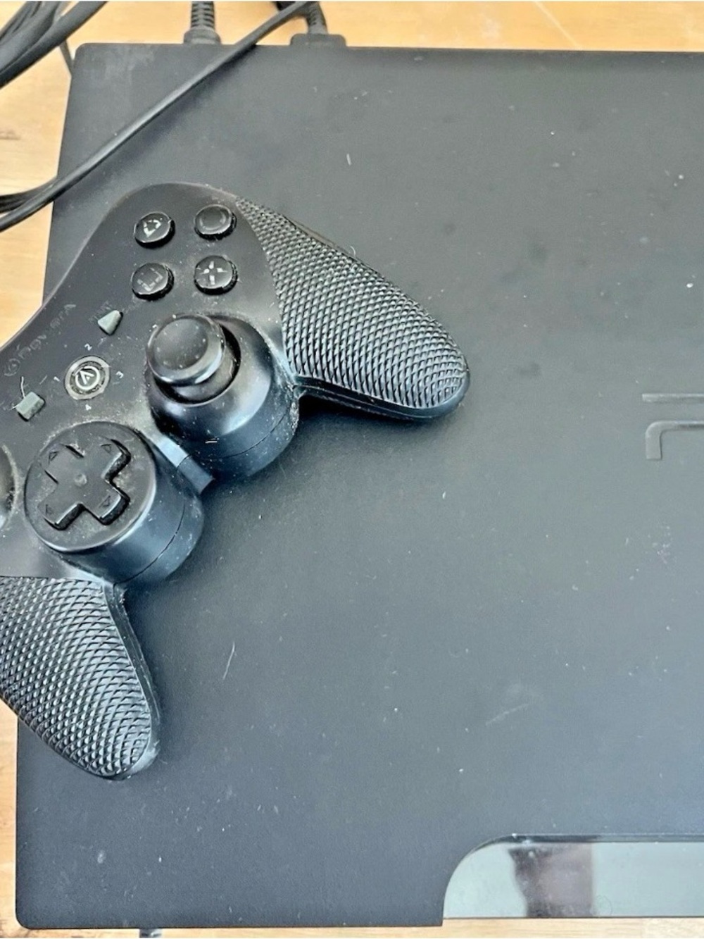 PlayStation 3 slim black console with HDMI and controller